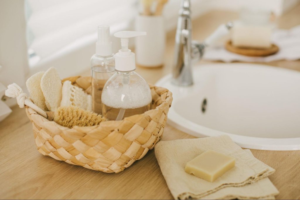 Bottle of soap in a wicker basket on a bathroom counter ©polinaloves